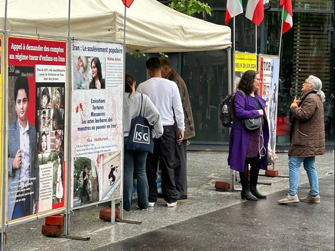 تقرير مصور - باريس - طاولة كتب ومعرض لصور شهداء الانتفاضة الإيرانية