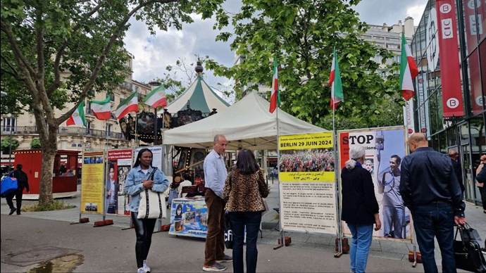 باريس وستوكهولم - طاولة كتاب ومعرض لصور شهداء الانتفاضة الإيرانية